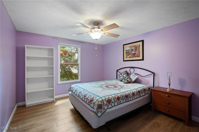 5802 Redwood Ct, Mentor-On-The-Lake, OH 44060 - bedroom with wood finished floors, a textured ceiling, and ceiling fan