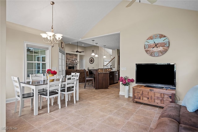 34782 Legends Way, Grafton, OH 44044 - dining space with a ceiling fan, a chandelier, high vaulted ceiling, and light tile patterned floors