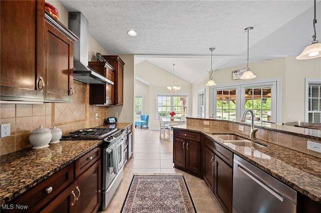34782 Legends Way, Grafton, OH 44044 - kitchen featuring stainless steel appliances, wall chimney exhaust hood, backsplash, lofted ceiling, and dark stone countertops