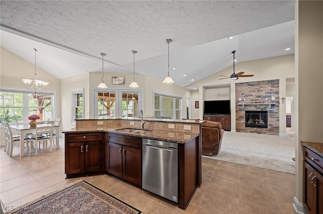 34782 Legends Way, Grafton, OH 44044 - kitchen featuring dishwasher, lofted ceiling, a fireplace, dark stone counters, and light tile patterned flooring