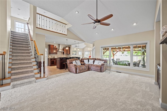 34782 Legends Way, Grafton, OH 44044 - living room with light carpet, ceiling fan, healthy amount of natural light, stairs, and high vaulted ceiling