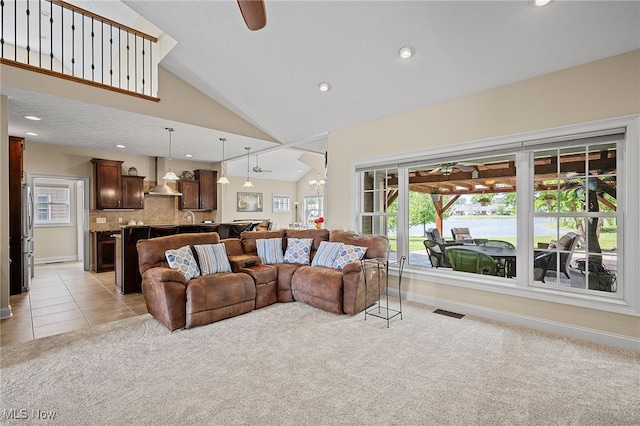 34782 Legends Way, Grafton, OH 44044 - living area featuring a ceiling fan, vaulted ceiling, light colored carpet, recessed lighting, and light tile patterned floors