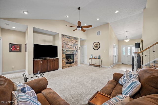 34782 Legends Way, Grafton, OH 44044 - living room featuring light carpet, vaulted ceiling, stairs, a fireplace, and ceiling fan