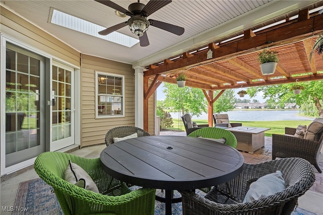 34782 Legends Way, Grafton, OH 44044 - view of patio / terrace with a water view, a pergola, a ceiling fan, outdoor dining area, and a jacuzzi