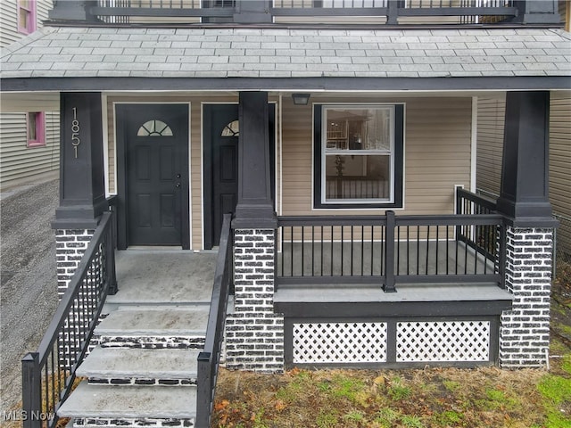 1851 W 52nd St, Cleveland, OH 44102 - view of exterior entry with roof with shingles and a porch