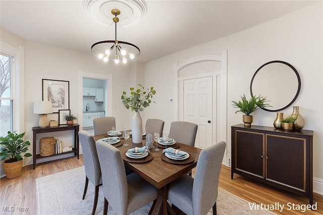 1851 W 52nd St, Cleveland, OH 44102 - dining space featuring a chandelier and wood finished floors