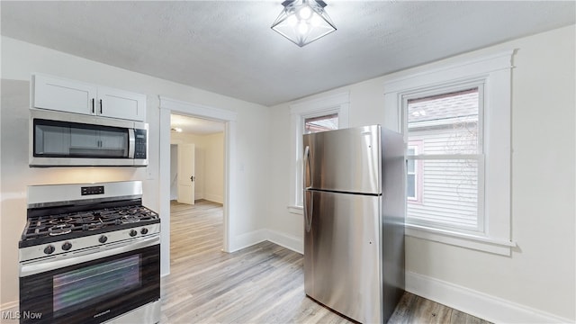 1851 W 52nd St, Cleveland, OH 44102 - kitchen with appliances with stainless steel finishes and light wood-style floors