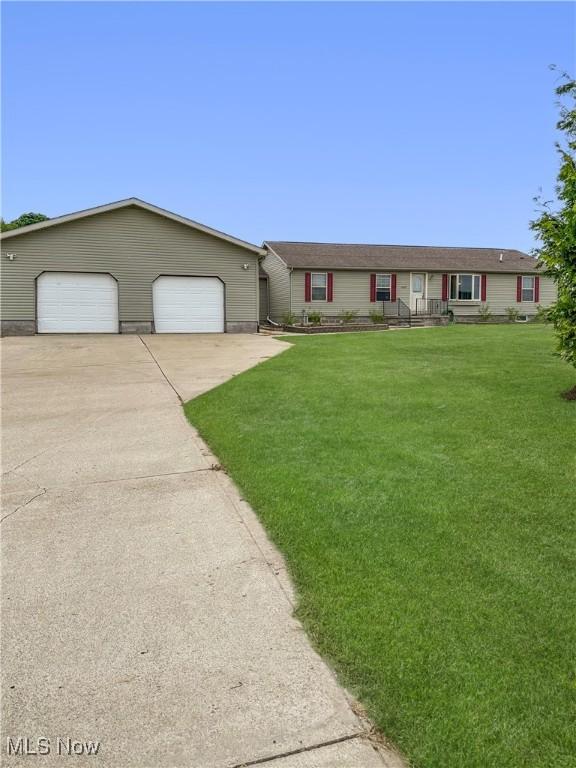 4182 Reger Rd, Conneaut, OH 44030 - ranch-style house featuring a front lawn and a garage