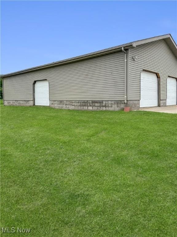 4182 Reger Rd, Conneaut, OH 44030 - view of side of home with a lawn and an attached garage