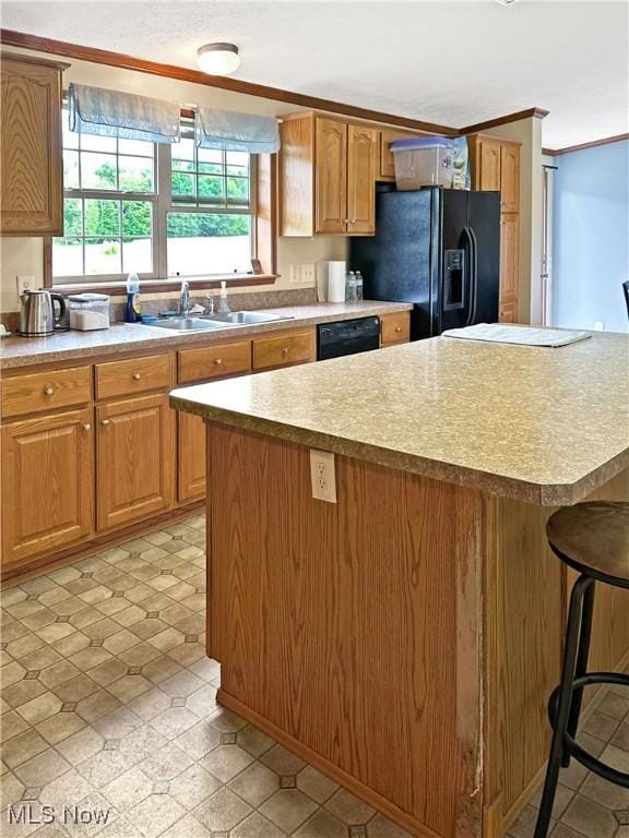 4182 Reger Rd, Conneaut, OH 44030 - kitchen featuring black appliances, a center island, a breakfast bar, light countertops, and ornamental molding