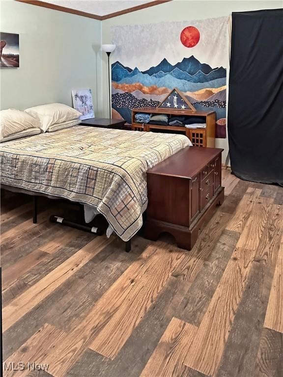 4182 Reger Rd, Conneaut, OH 44030 - bedroom with hardwood / wood-style floors and crown molding