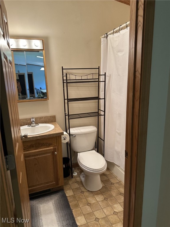 4182 Reger Rd, Conneaut, OH 44030 - full bath with vanity, a shower with curtain, and tile patterned flooring