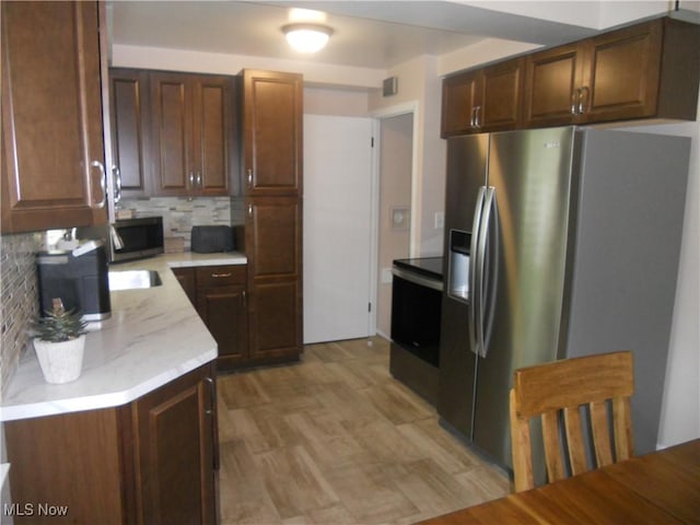 374 Clarmont Rd, Willowick, OH 44095 - kitchen with stainless steel appliances and backsplash