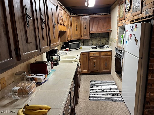 382 Bluestone Dr, Weirton, WV 26062 - kitchen with white appliances, tile counters, brown cabinetry, and backsplash