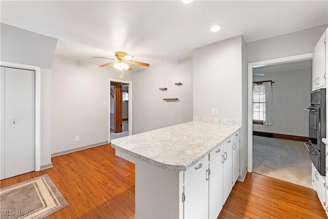 119 5th St SW, Strasburg, OH 44680 - kitchen with a peninsula, light countertops, a ceiling fan, oven, and a warming drawer