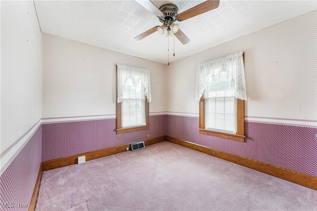 119 5th St SW, Strasburg, OH 44680 - carpeted empty room with healthy amount of natural light and a ceiling fan