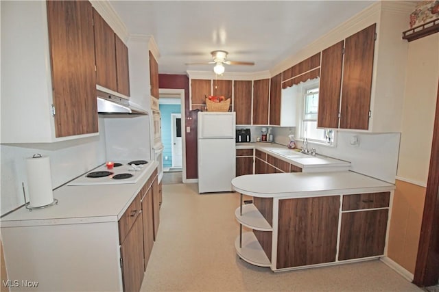 517 Linwood Ct, Port Clinton, OH 43452 - kitchen featuring under cabinet range hood, white appliances, light countertops, and a peninsula