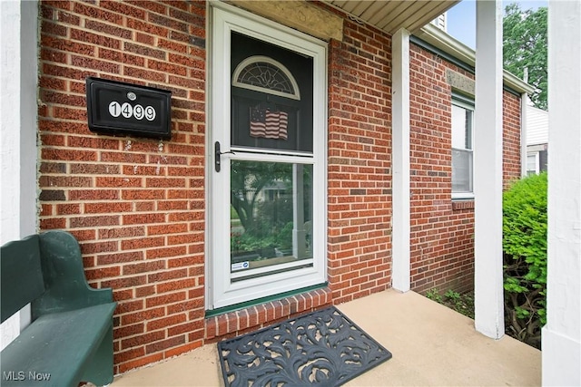 1499 Redwood Ave, Akron, OH 44301 - view of exterior entry with brick siding and a porch