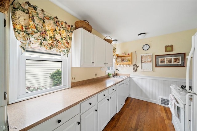 1499 Redwood Ave, Akron, OH 44301 - kitchen with white appliances, dark wood-type flooring, wainscoting, white cabinetry, and healthy amount of natural light