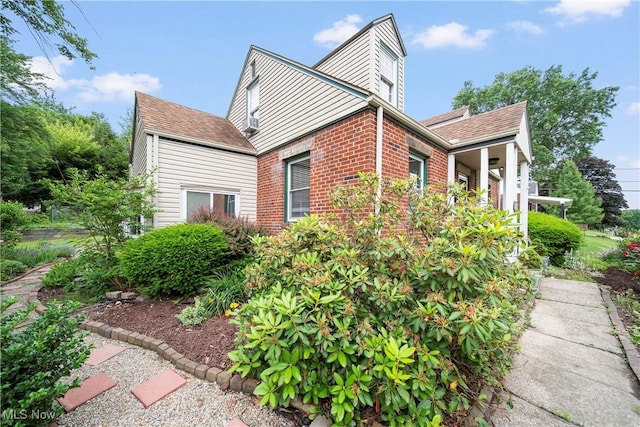 1499 Redwood Ave, Akron, OH 44301 - view of home's exterior featuring brick siding and a shingled roof
