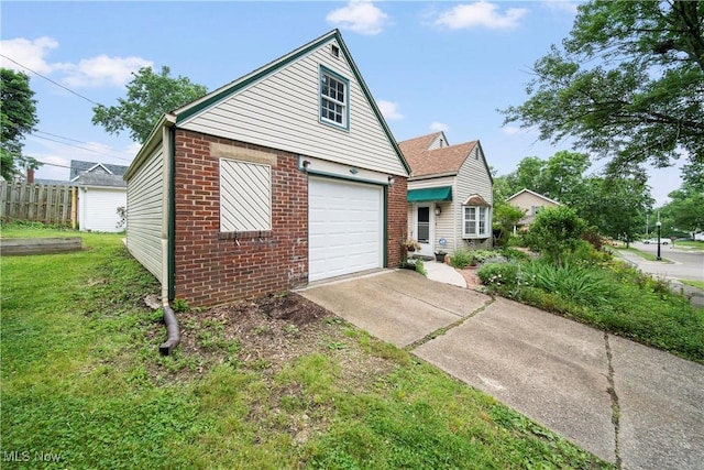 1499 Redwood Ave, Akron, OH 44301 - view of front facade featuring brick siding and driveway