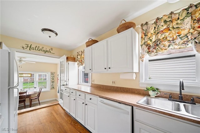 1499 Redwood Ave, Akron, OH 44301 - kitchen featuring white appliances, white cabinetry, light wood-type flooring, and ceiling fan