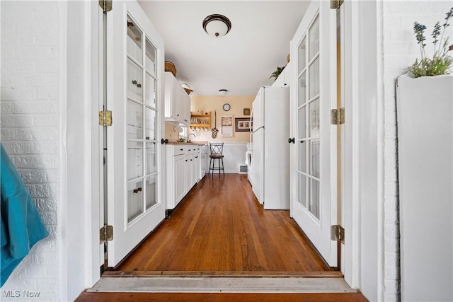 1499 Redwood Ave, Akron, OH 44301 - hall featuring dark wood-style floors and french doors