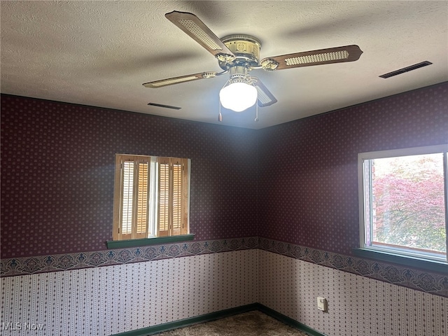 108 Janet Rd, Marietta, OH 45750 - empty room featuring a ceiling fan, a textured ceiling, and dark carpet