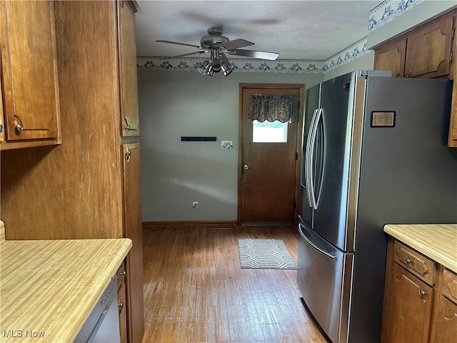 108 Janet Rd, Marietta, OH 45750 - kitchen with freestanding refrigerator, hardwood / wood-style floors, ceiling fan, light countertops, and brown cabinets