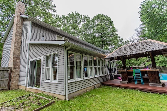 449 Westchester Dr SE, Warren, OH 44484 - rear view of house with a wooden deck, a chimney, a gazebo, and an outdoor pool
