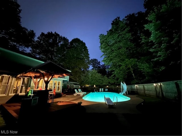 449 Westchester Dr SE, Warren, OH 44484 - view of pool featuring a water slide, a patio, and a fenced backyard