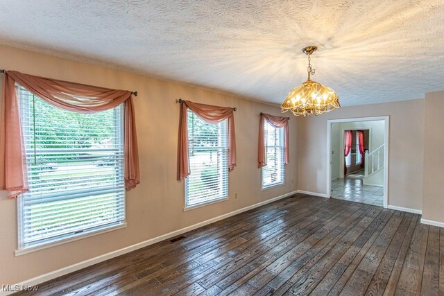 449 Westchester Dr SE, Warren, OH 44484 - empty room with a chandelier, wood-type flooring, and a textured ceiling