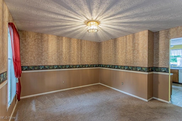 449 Westchester Dr SE, Warren, OH 44484 - carpeted empty room featuring wallpapered walls and a textured ceiling