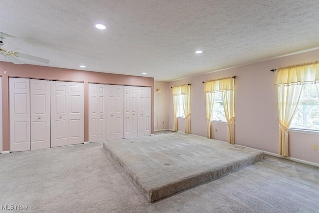 449 Westchester Dr SE, Warren, OH 44484 - unfurnished bedroom featuring carpet, multiple windows, two closets, recessed lighting, and a textured ceiling