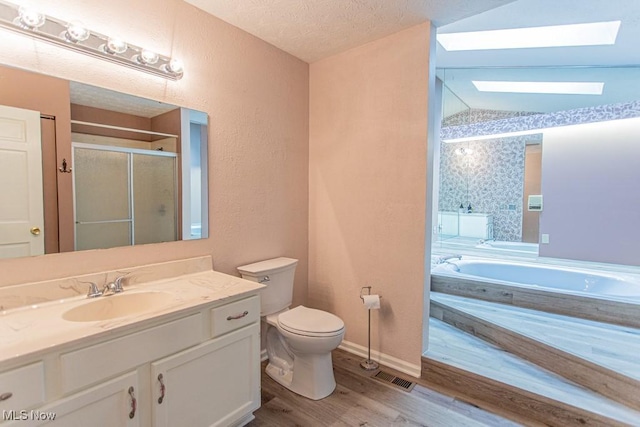 449 Westchester Dr SE, Warren, OH 44484 - full bathroom featuring a bath, a shower stall, vanity, wood finished floors, and a textured ceiling