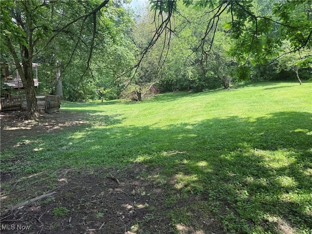 19693 Dudley Rd, Caldwell, OH 43724 - view of green lawn featuring a forest view and a wooden deck
