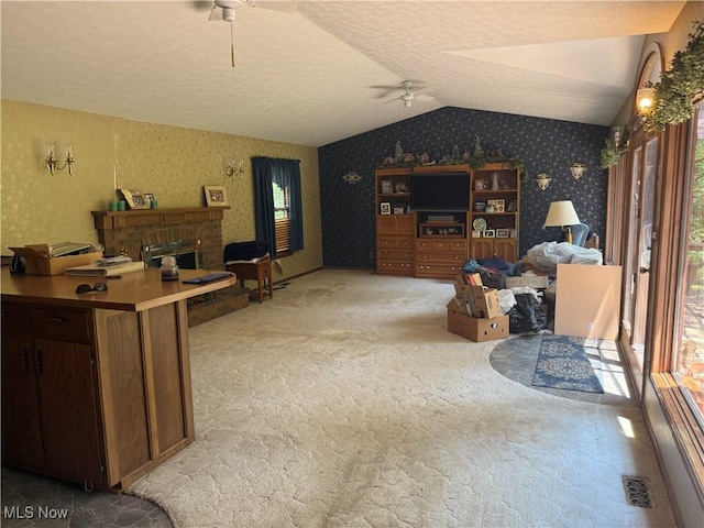 19693 Dudley Rd, Caldwell, OH 43724 - living area featuring ceiling fan, wallpapered walls, light colored carpet, vaulted ceiling, and a textured ceiling