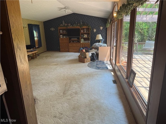 19693 Dudley Rd, Caldwell, OH 43724 - unfurnished living room with wallpapered walls, carpet floors, vaulted ceiling, and ceiling fan