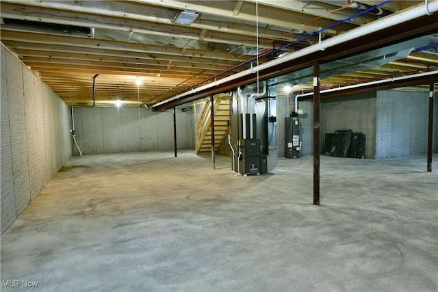 2320 Wilshire Dr, Cortland, OH 44410 - unfinished basement featuring water heater, stairs, and heating unit