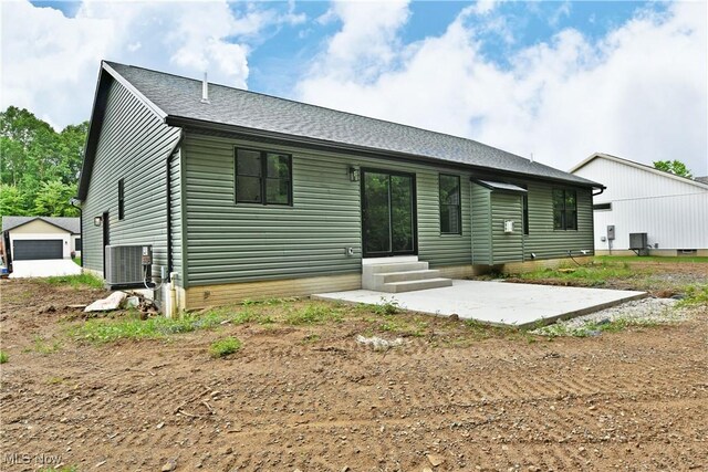 2320 Wilshire Dr, Cortland, OH 44410 - rear view of property featuring entry steps, a patio, and a shingled roof