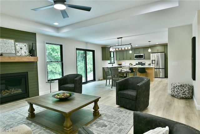 2320 Wilshire Dr, Cortland, OH 44410 - living room with a glass covered fireplace, light wood finished floors, ceiling fan, and recessed lighting