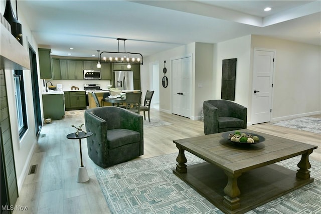 2320 Wilshire Dr, Cortland, OH 44410 - living area featuring light wood finished floors, recessed lighting, and a chandelier