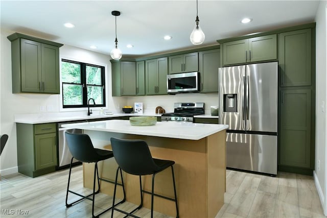 2320 Wilshire Dr, Cortland, OH 44410 - kitchen with stainless steel appliances, green cabinetry, light wood-style flooring, pendant lighting, and recessed lighting