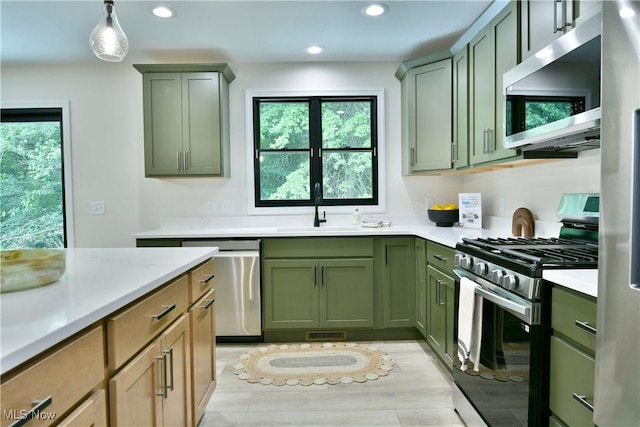2320 Wilshire Dr, Cortland, OH 44410 - kitchen featuring stainless steel appliances, green cabinetry, light countertops, recessed lighting, and pendant lighting