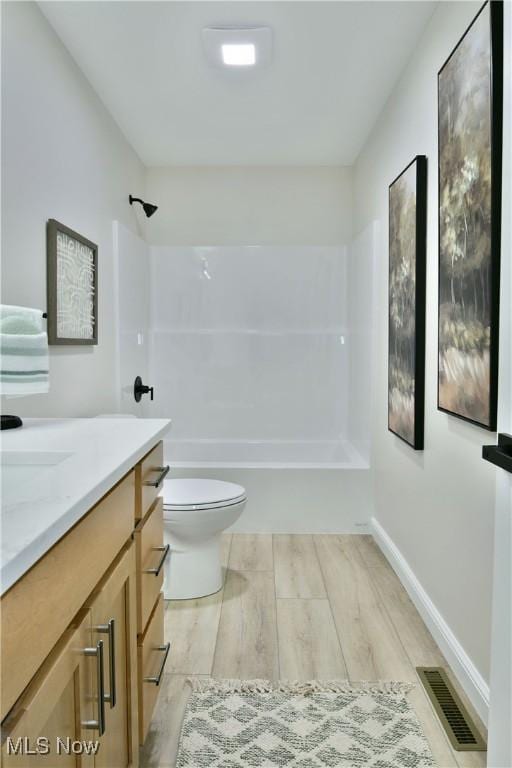 2320 Wilshire Dr, Cortland, OH 44410 - full bathroom featuring wood finished floors, vanity, and bathtub / shower combination