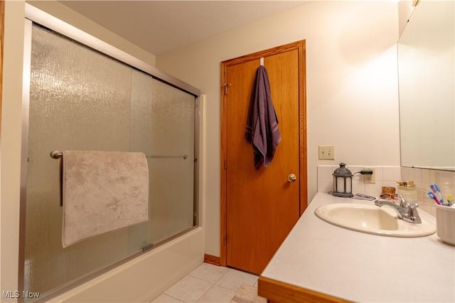 10393 Scotney Ave NW, North Canton, OH 44720 - full bath featuring tile patterned floors, bath / shower combo with glass door, and vanity