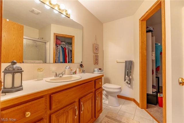 10393 Scotney Ave NW, North Canton, OH 44720 - bathroom with a walk in closet, vanity, tile patterned floors, and a shower stall