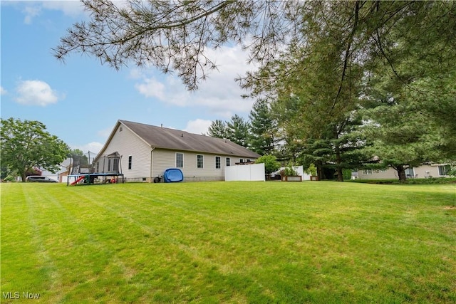 10393 Scotney Ave NW, North Canton, OH 44720 - view of grassy yard with a trampoline