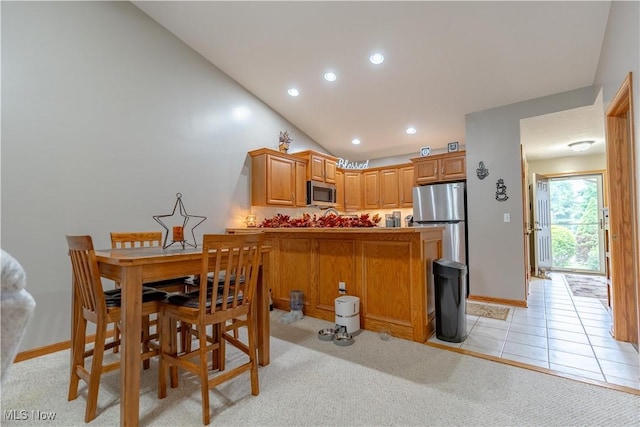 10393 Scotney Ave NW, North Canton, OH 44720 - dining space featuring recessed lighting, vaulted ceiling, and light tile patterned floors