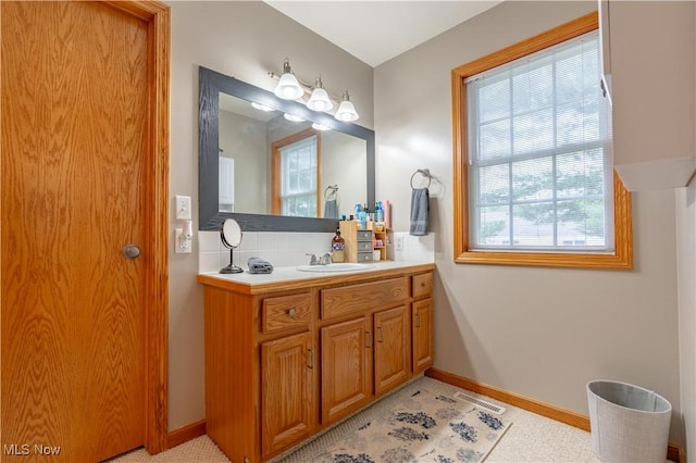 10393 Scotney Ave NW, North Canton, OH 44720 - bathroom featuring tasteful backsplash and vanity